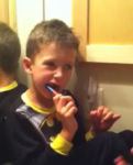 Aiden is brushing his teeth.